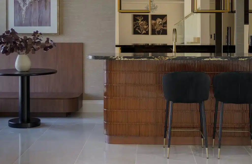 A stylish modern kitchen with two black stools, highlighting a clean design and functional layout.